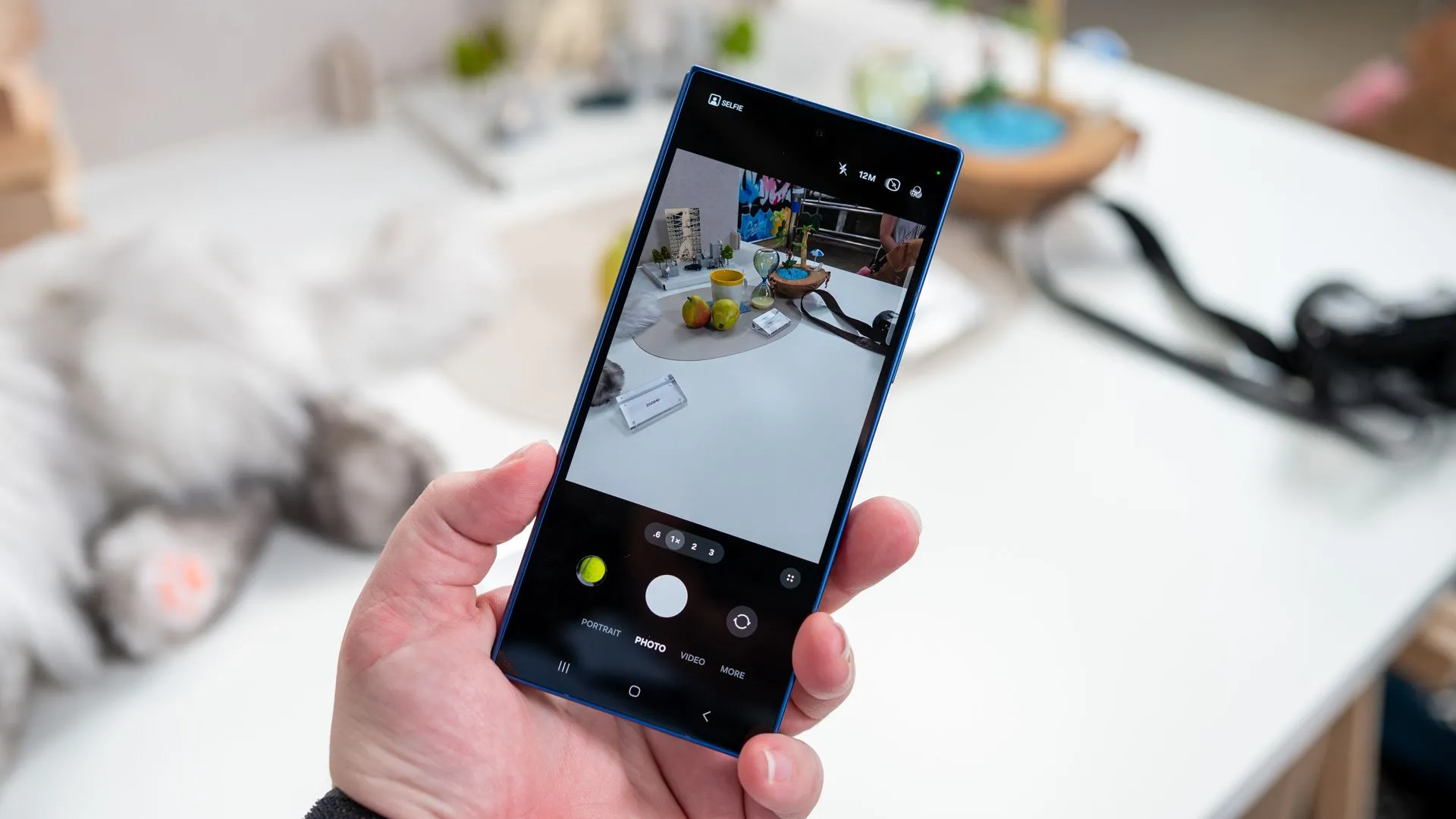 Người đang cầm Samsung Galaxy Z Fold 7 gập lại hiển thị ứng dụng camera
