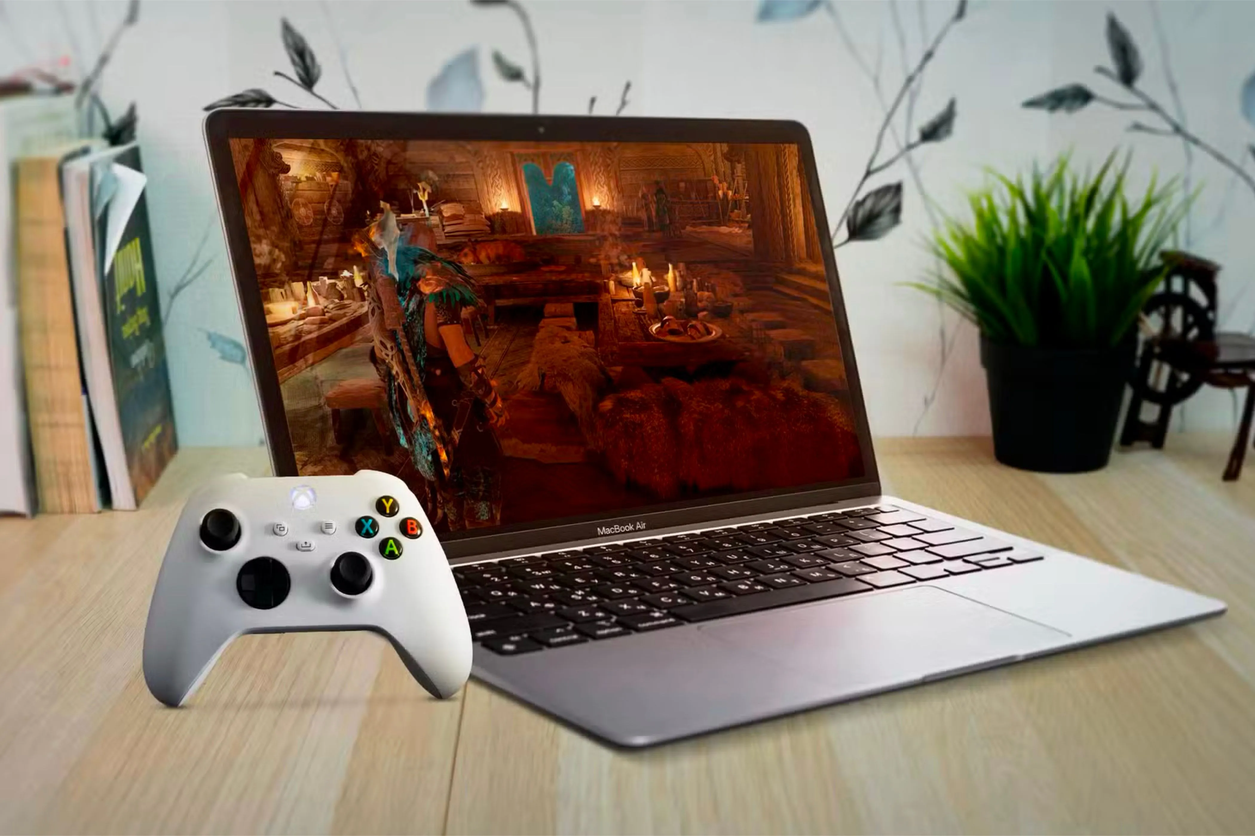 Người dùng đang chơi game trên MacBook Air với tay cầm Xbox, minh họa việc tối ưu macOS để chơi game mượt mà hơn